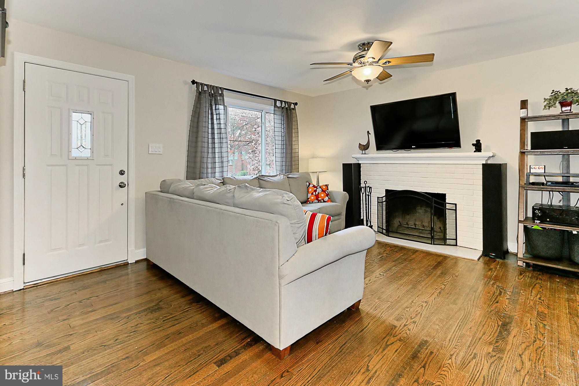 5906 Craig Street Springfield, VA 22150 - Photo 6 of 54 Living room with cozy, wood-burning fireplace