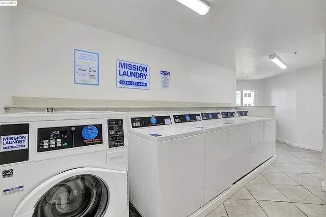 a patio with a table and chairs and potted plants