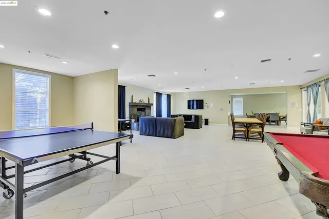 a bedroom with furniture and a large window