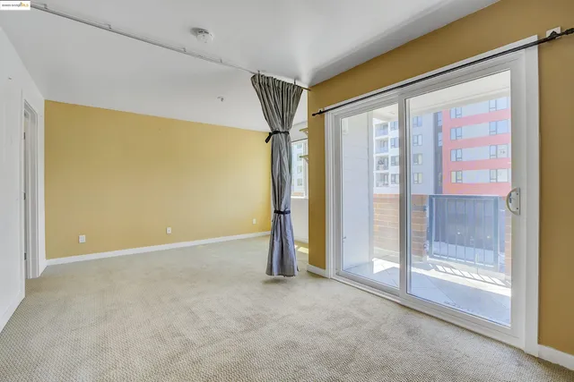 a kitchen with a sink dishwasher a stove and white cabinets with wooden floor