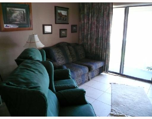 3938 Surfside, Unit 3113 Corpus Christi, TX 78402 - Photo 2 of 5 a living room with furniture and a window