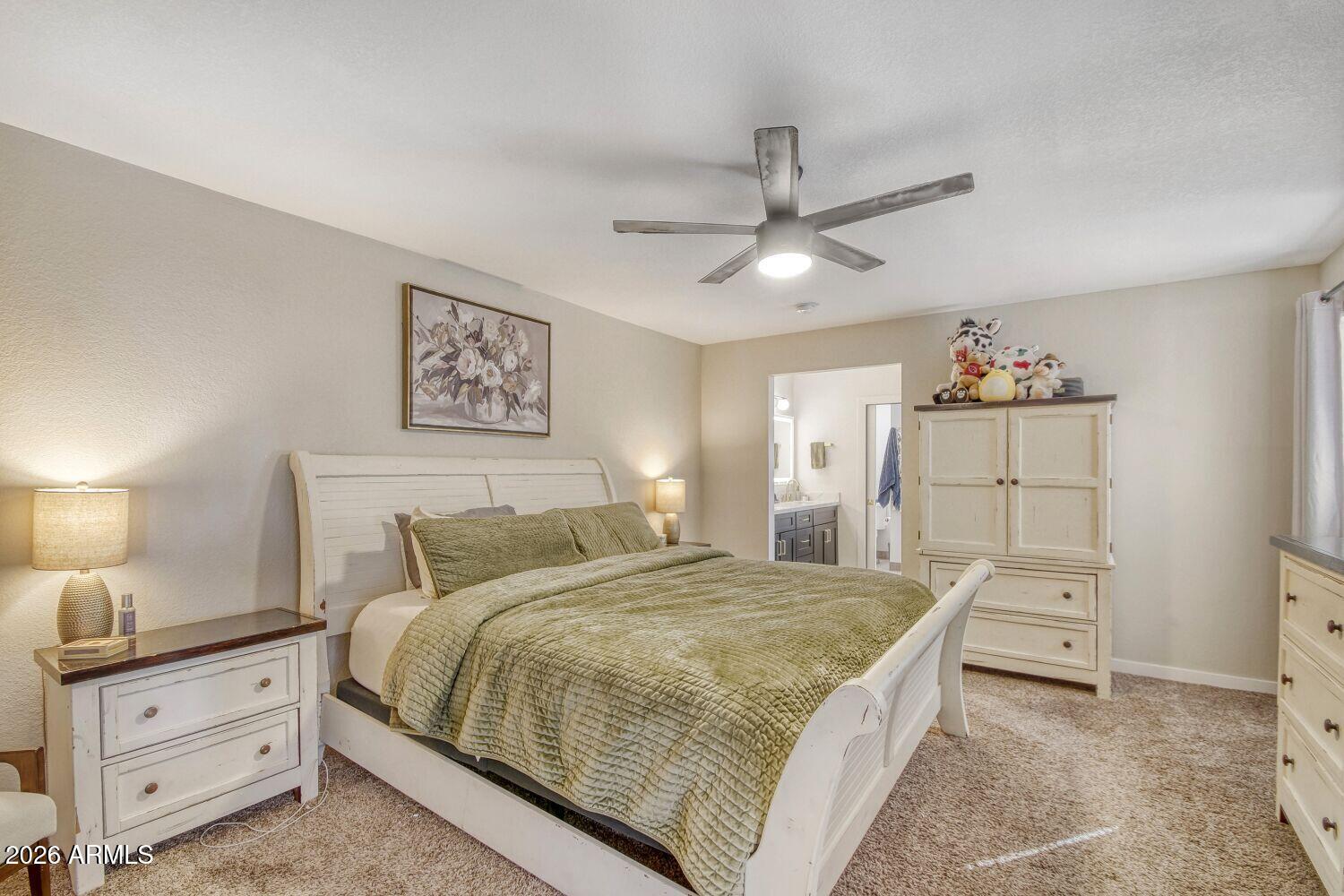 720 West Thunderbird Road Phoenix, AZ 85023 - Photo 15 of 28 a bedroom with a bed and a chandelier