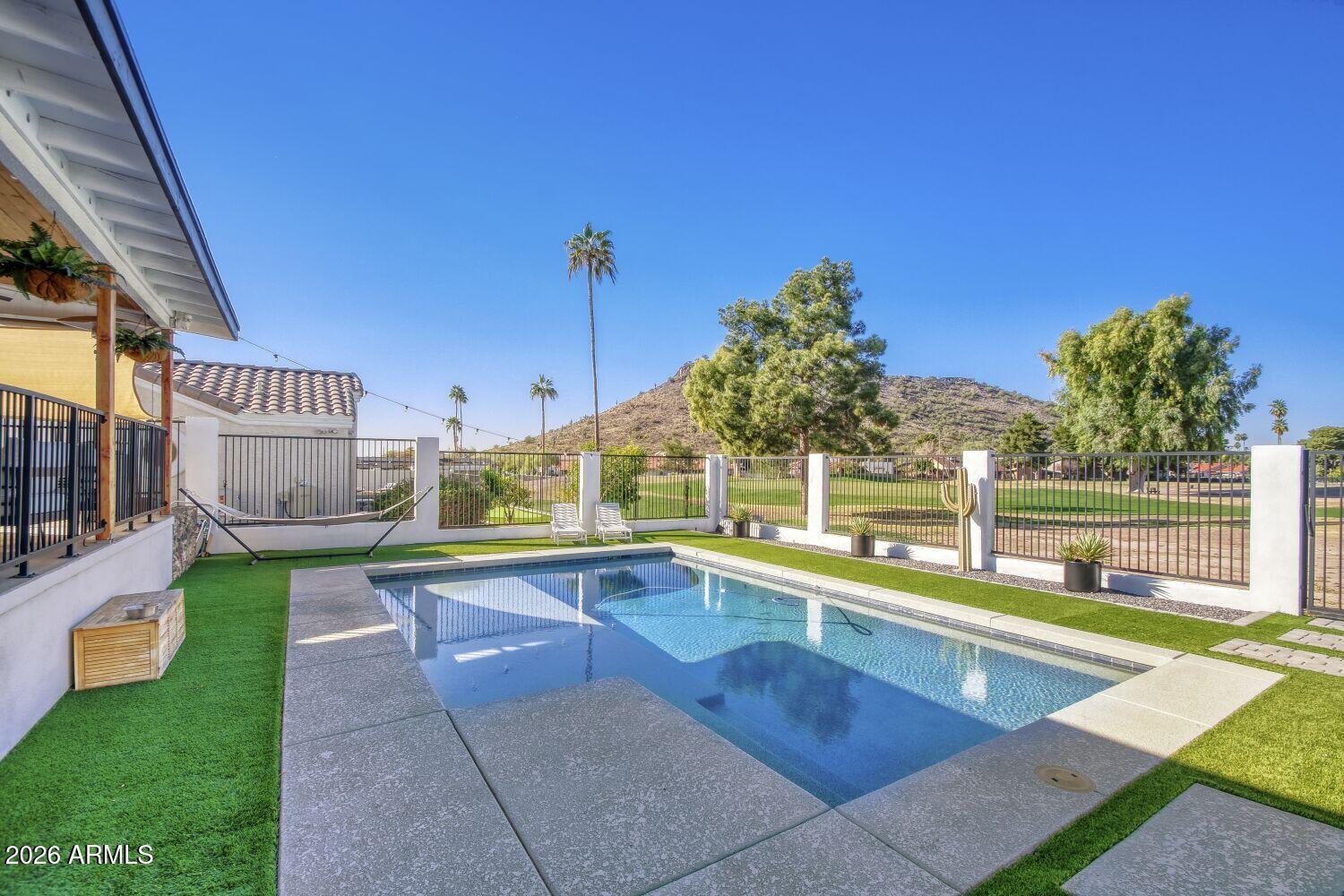 720 West Thunderbird Road Phoenix, AZ 85023 - Photo 23 of 28 a view of a swimming pool with a lounge chairs