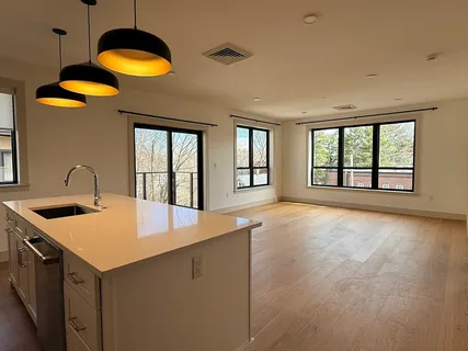 a kitchen with a stove top oven and a sink