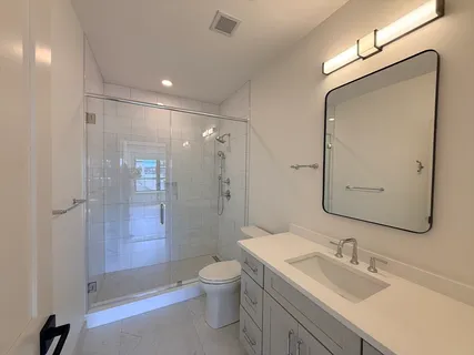 a bedroom with bed couch and window