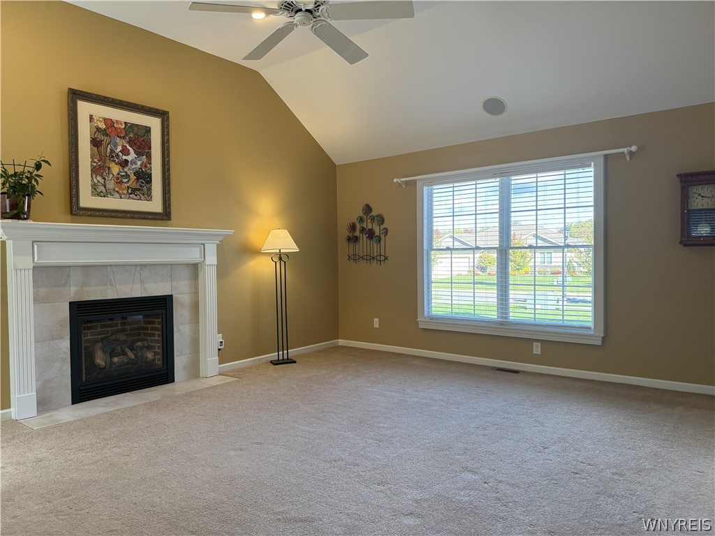 73 Chestnut Lancaster, NY 14086 - Photo 8 of 41 Vaulted ceilings and a classic fireplace anchor this inviting living space.