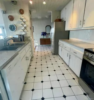 a kitchen with stainless steel appliances granite countertop a sink and cabinets