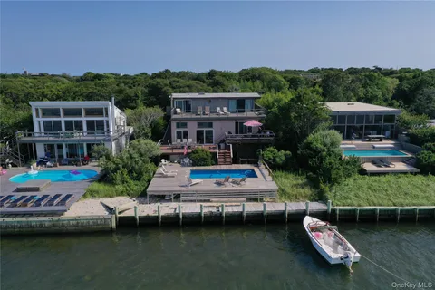 a view of swimming pool with outdoor seating and a garden