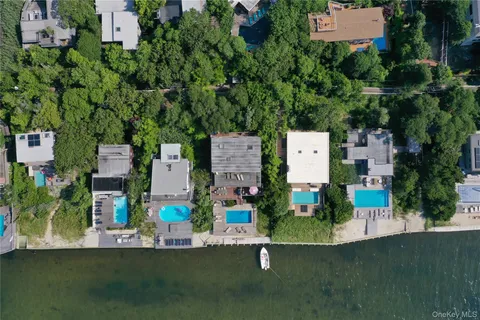 an aerial view of a house with a garden and parking space