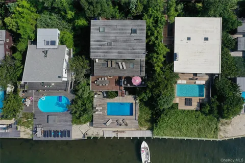 an aerial view of a house with outdoor space pool seating area and yard