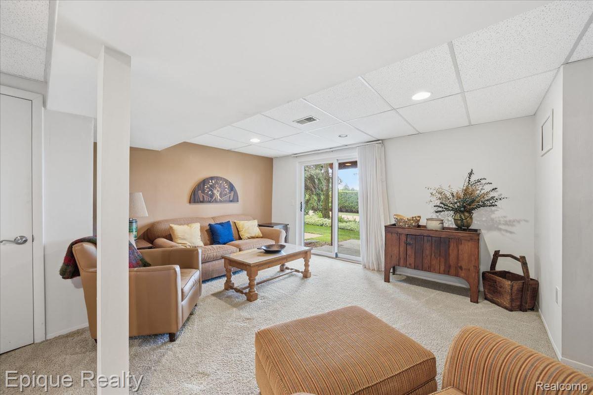 26 Kirks Court Rochester, MI 48309 - Photo 29 of 44 Carpeted recreation room featuring recessed lighting, a sliding glass door to exterior, and a drop ceiling