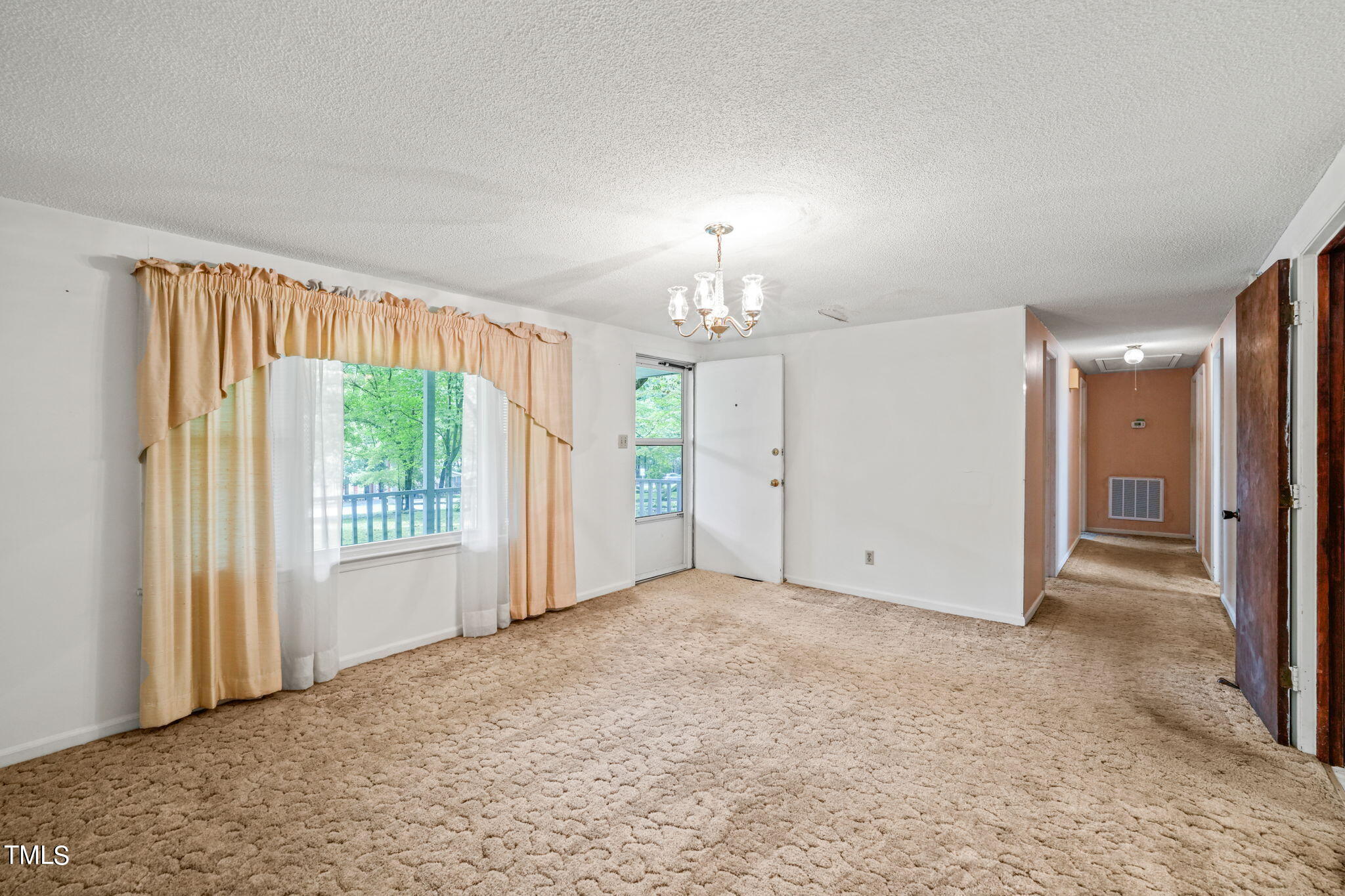 3015 Old Raleigh Road Apex, NC 27502 - Photo 9 of 47 an empty room with chandelier fan and windows