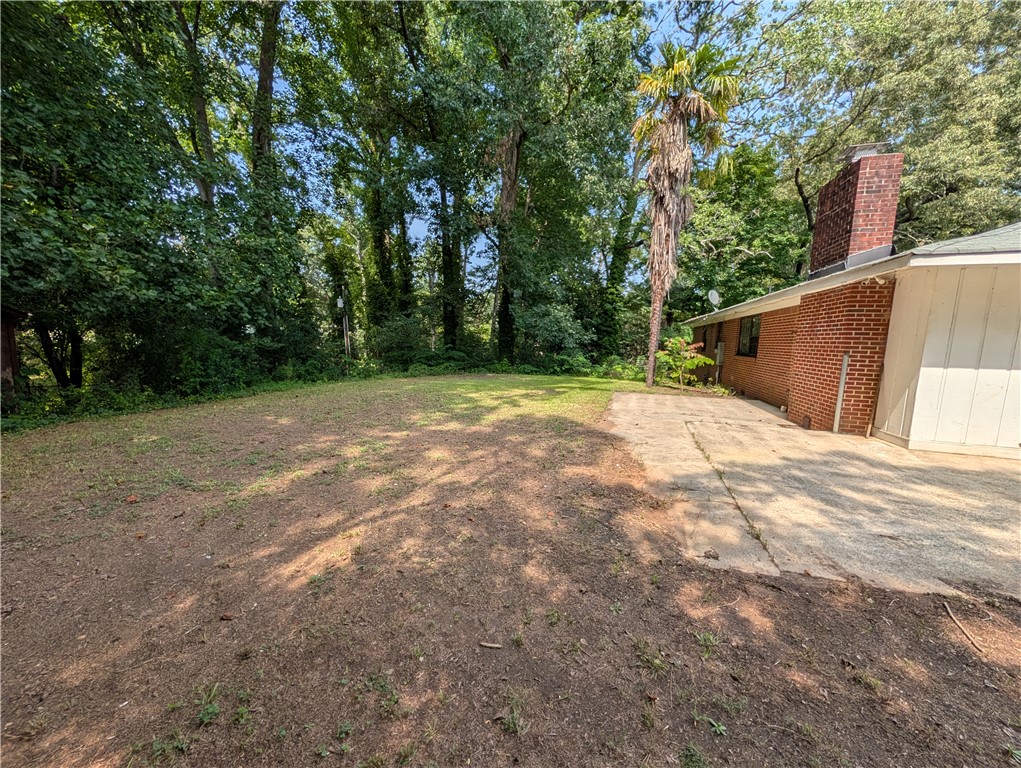 203 Glendale Road Anderson, SC 29624 - Photo 20 of 20 Mature trees and a brick-sided home frame a generously sized private yard.