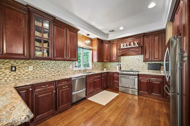 a living room with furniture ceiling fan and a large window