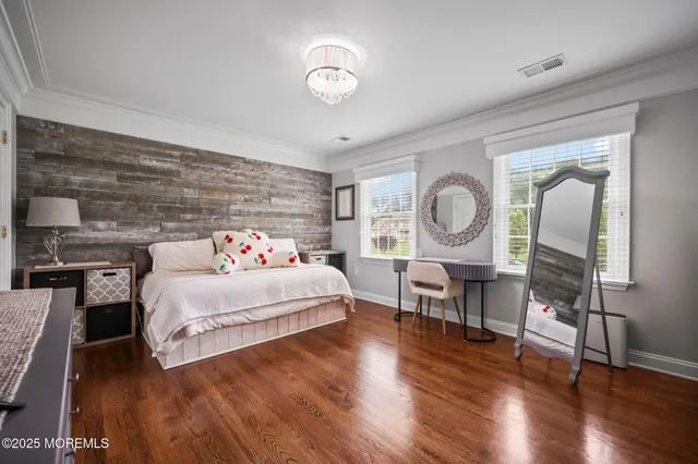 a room with stainless steel appliances wooden floor table and chairs