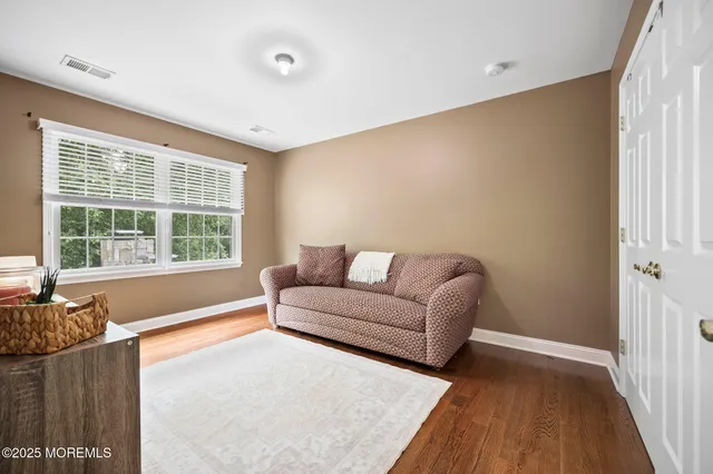 a kitchen with a sink and a stove with wooden floor