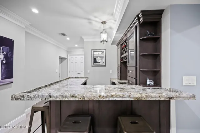 a view of a dining room with furniture kitchen and chandelier