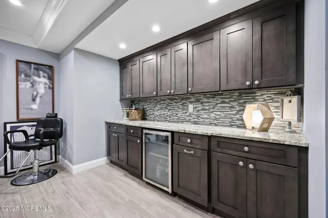 a kitchen with a table chairs stove and wooden floor