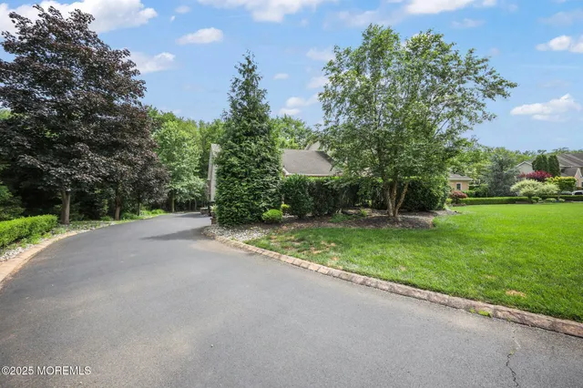 a bathroom with a granite countertop toilet sink and mirror