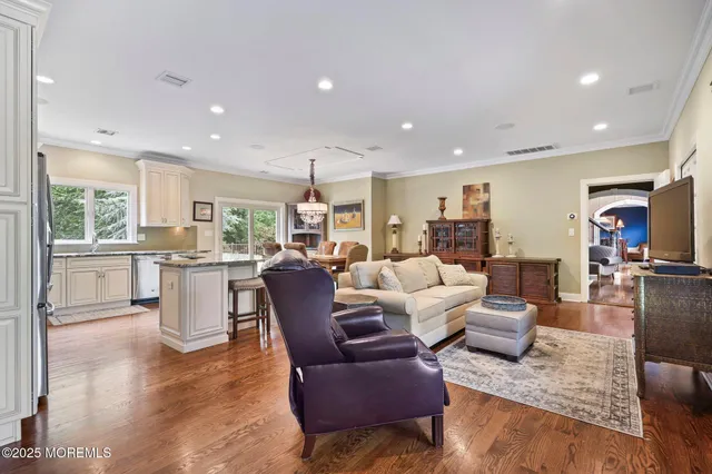 a view of a patio with table and chairs potted plants and large tree
