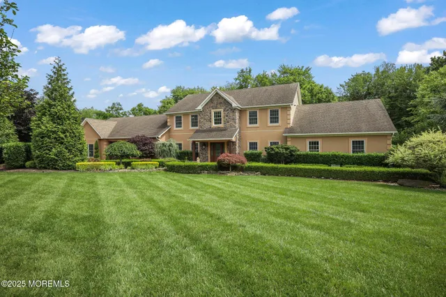 a front view of a house with a yard table and chairs