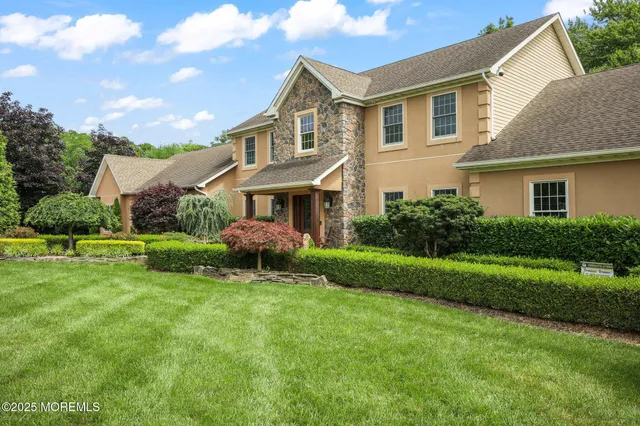 a front view of a house with a yard porch and outdoor seating