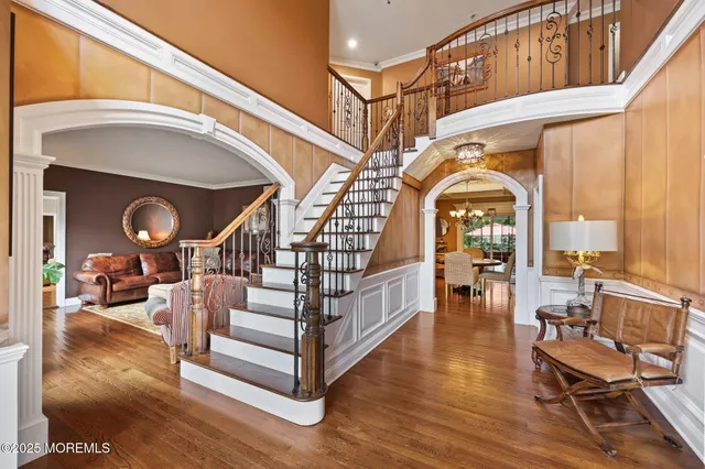 a view of a dining room with furniture a chandelier and wooden floor