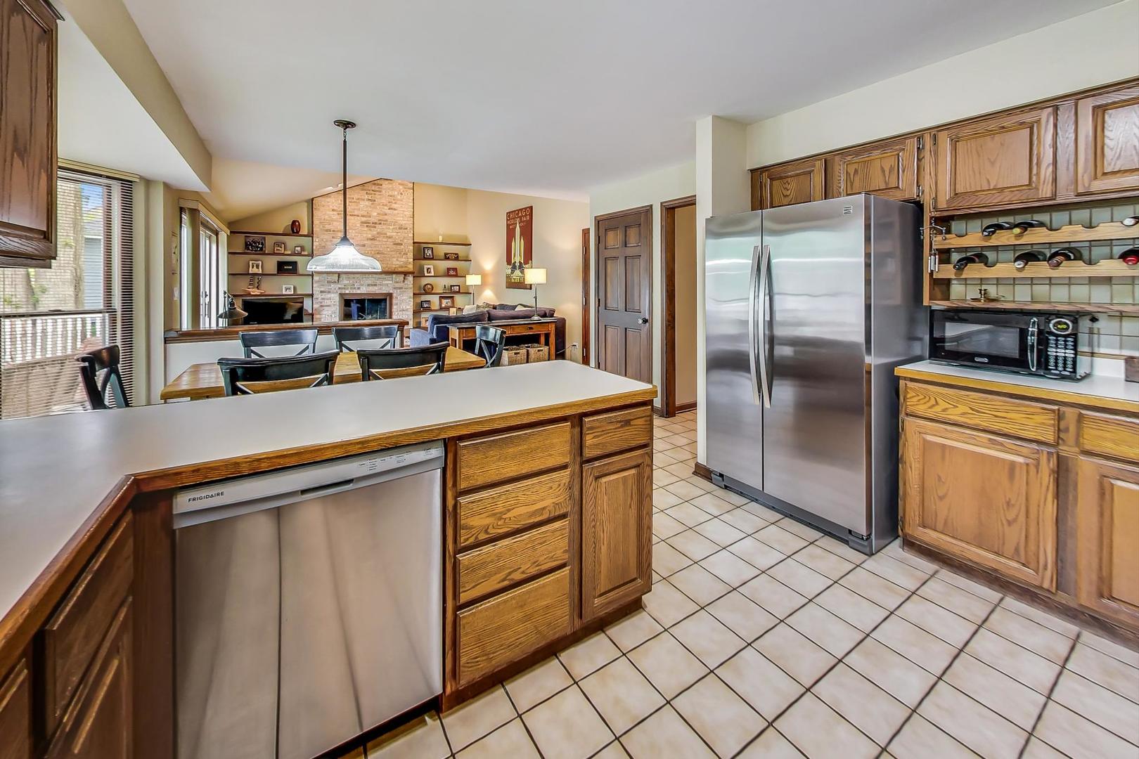 482 West 3rd Street Elmhurst, IL 60126 - Photo 11 of 39 a kitchen with stainless steel appliances a refrigerator sink and cabinets