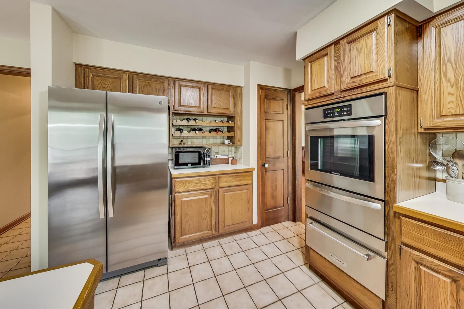 482 West 3rd Street Elmhurst, IL 60126 - Photo 12 of 39 a kitchen with granite countertop cabinets and stainless steel appliances