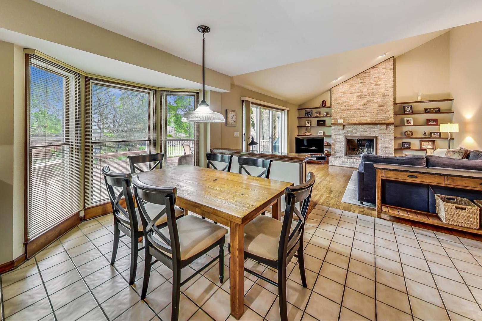 482 West 3rd Street Elmhurst, IL 60126 - Photo 13 of 39 a dining room with furniture a chandelier and wooden floor