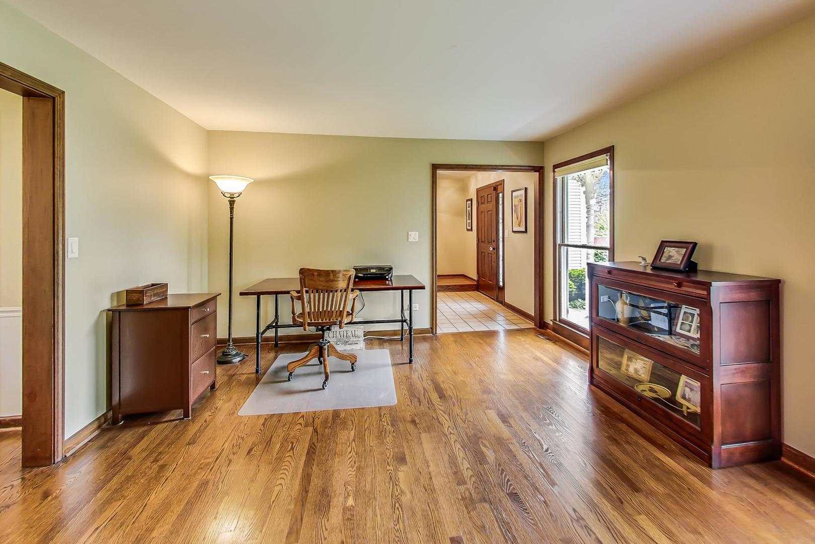 482 West 3rd Street Elmhurst, IL 60126 - Photo 7 of 39 a living room with furniture a rug and a floor to ceiling window