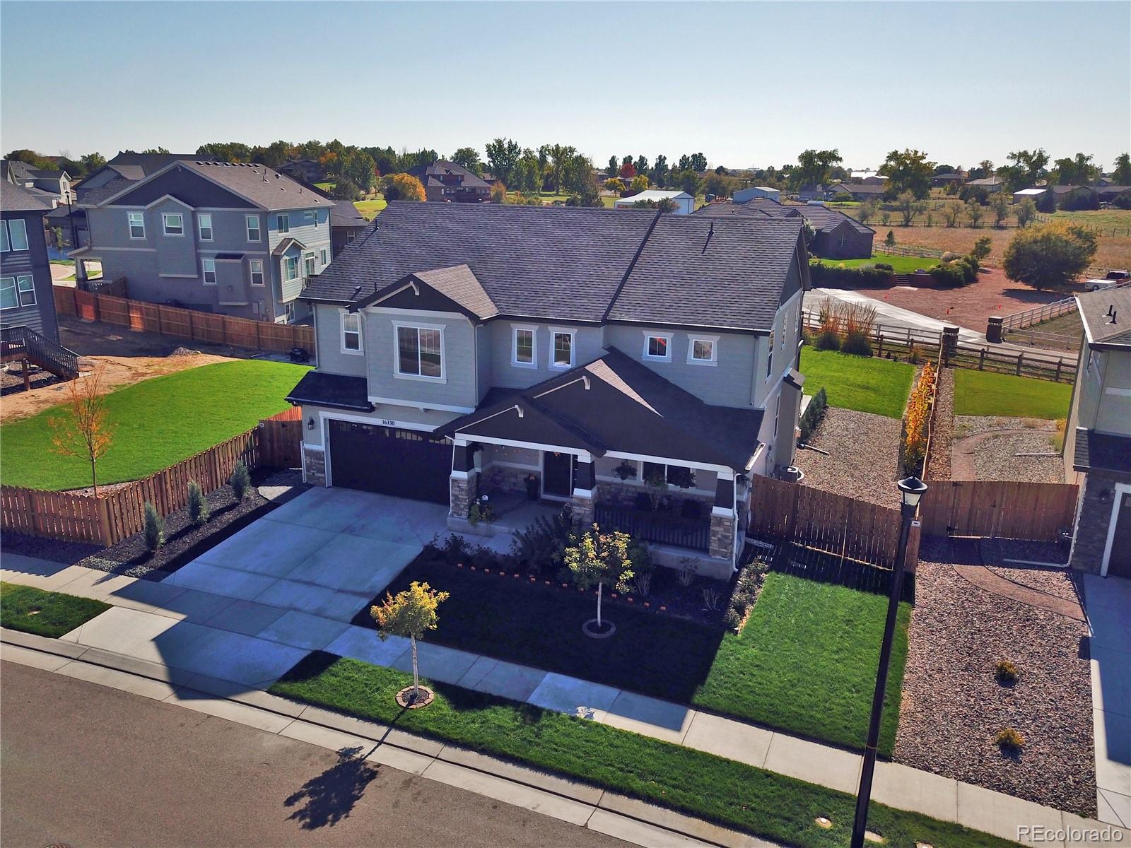 an aerial view of a house with a garden and houses