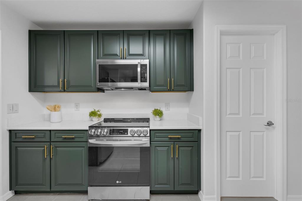 15038 Willow Lane Tavares, FL 32778 - Photo 15 of 37 a kitchen with stainless steel appliances granite countertop a stove a microwave and cabinets