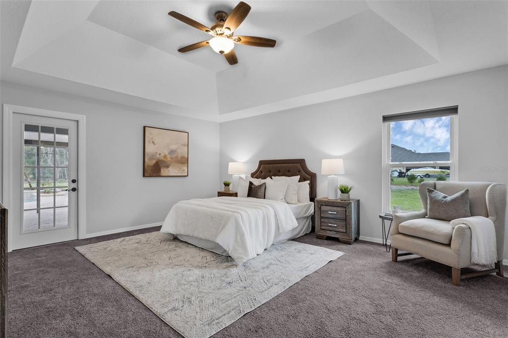 15038 Willow Lane Tavares, FL 32778 - Photo 17 of 37 a spacious bedroom with a bed and ceiling fan
