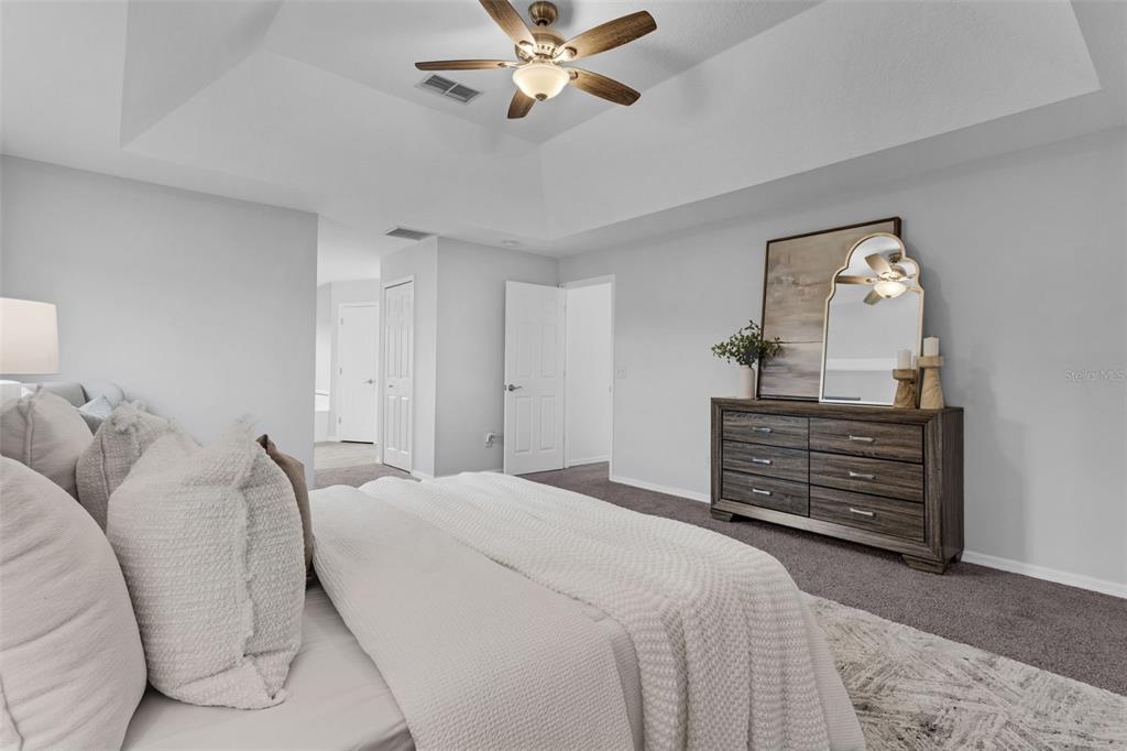 15038 Willow Lane Tavares, FL 32778 - Photo 18 of 37 a bedroom with a bed and a chandelier