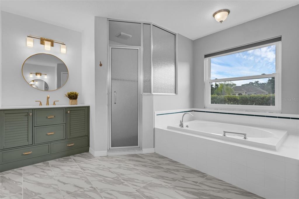 15038 Willow Lane Tavares, FL 32778 - Photo 21 of 37 a bathroom with a tub sink and mirror