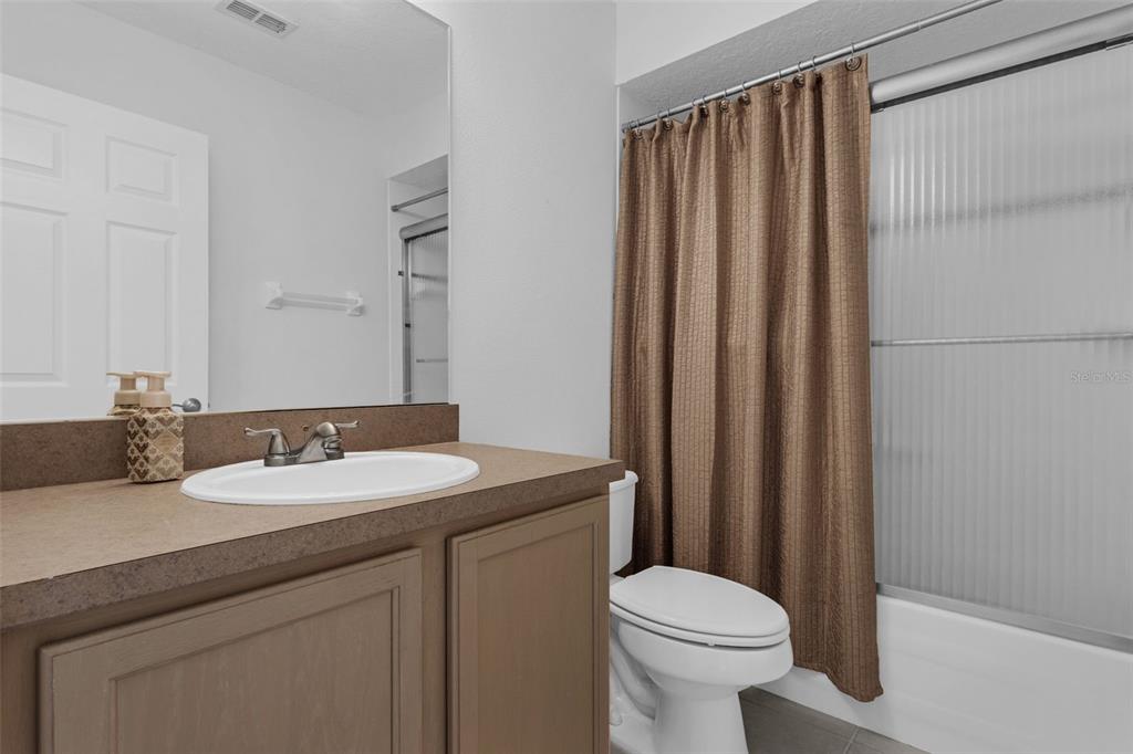 15038 Willow Lane Tavares, FL 32778 - Photo 23 of 37 a bathroom with a sink a toilet and shower