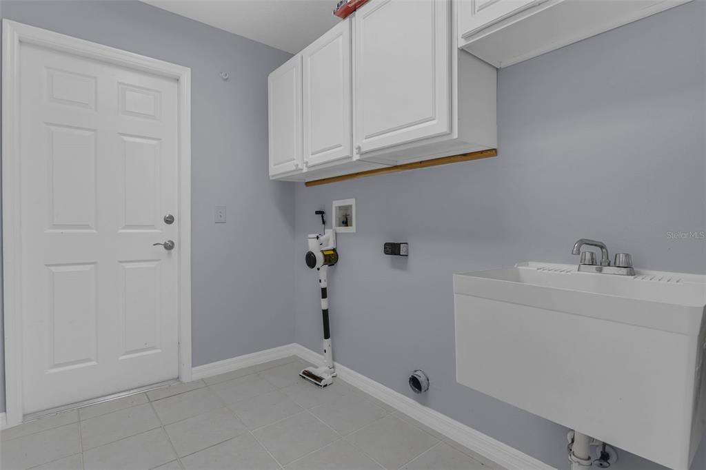 15038 Willow Lane Tavares, FL 32778 - Photo 25 of 37 a bathroom with a sink and cabinets