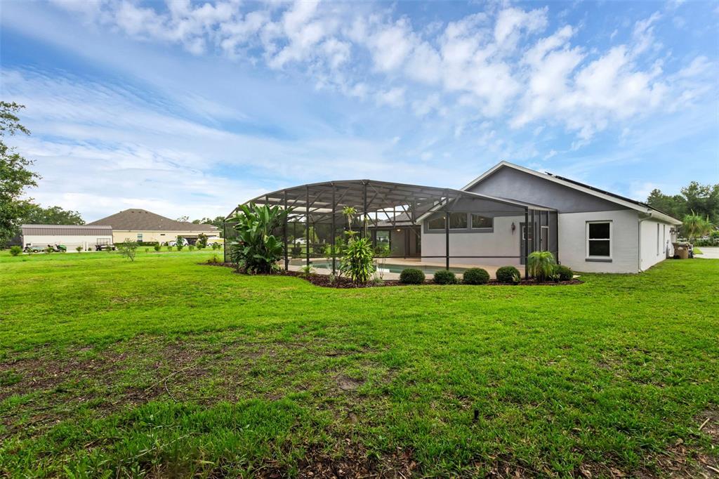 15038 Willow Lane Tavares, FL 32778 - Photo 31 of 37 a view of a house with a big yard potted plants and large tree