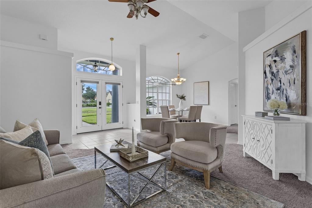 15038 Willow Lane Tavares, FL 32778 - Photo 4 of 37 a living room with furniture potted plant and a chandelier