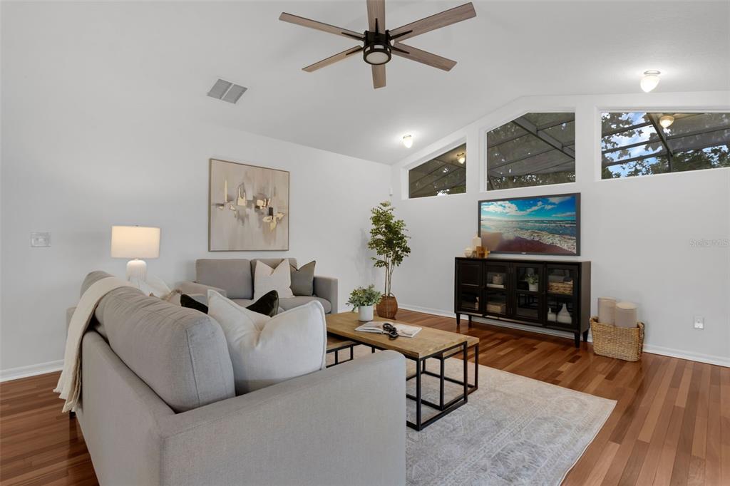 15038 Willow Lane Tavares, FL 32778 - Photo 8 of 37 a living room with furniture a fireplace and wooden floor