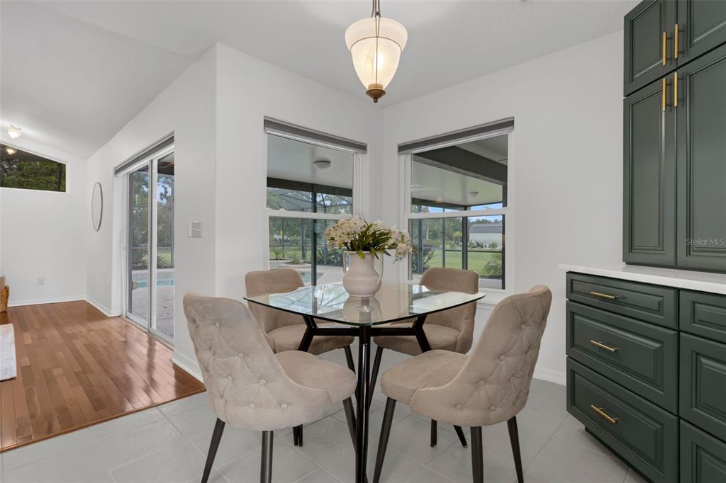 15038 Willow Lane Tavares, FL 32778 - Photo 10 of 37 a view of a dining room with furniture and wooden floor