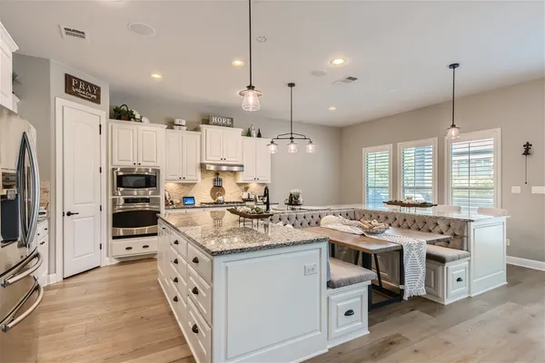a kitchen with a stove and a refrigerator