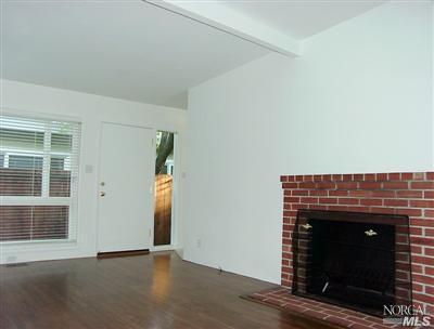2070 Fifth Avenue San Rafael, CA 94901 - Photo 4 of 6 a view of an empty room with wooden floor and a fireplace
