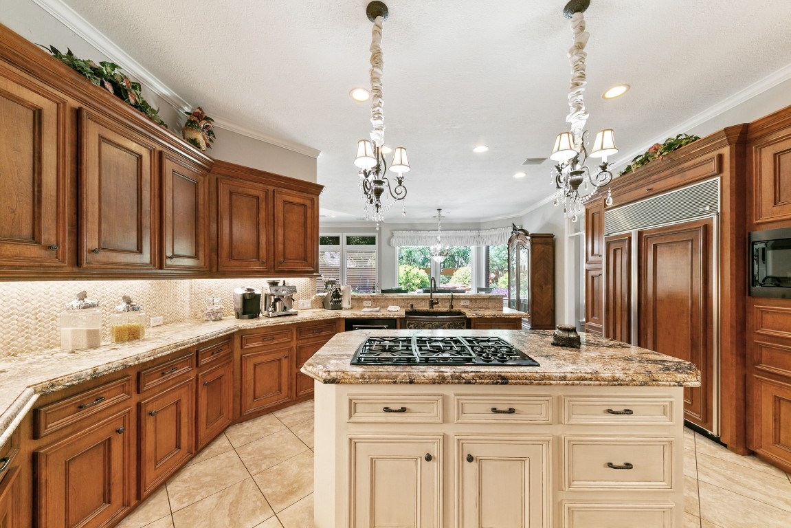 13915 Springmint Drive Cypress, TX 77429 - Photo 11 of 43 Sophisticated center island with a professional-grade gas cooktop, combining function and style at the heart of the gourmet kitchen