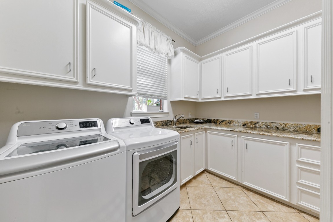 13915 Springmint Drive Cypress, TX 77429 - Photo 17 of 43 a kitchen with granite countertop white cabinets and white appliances