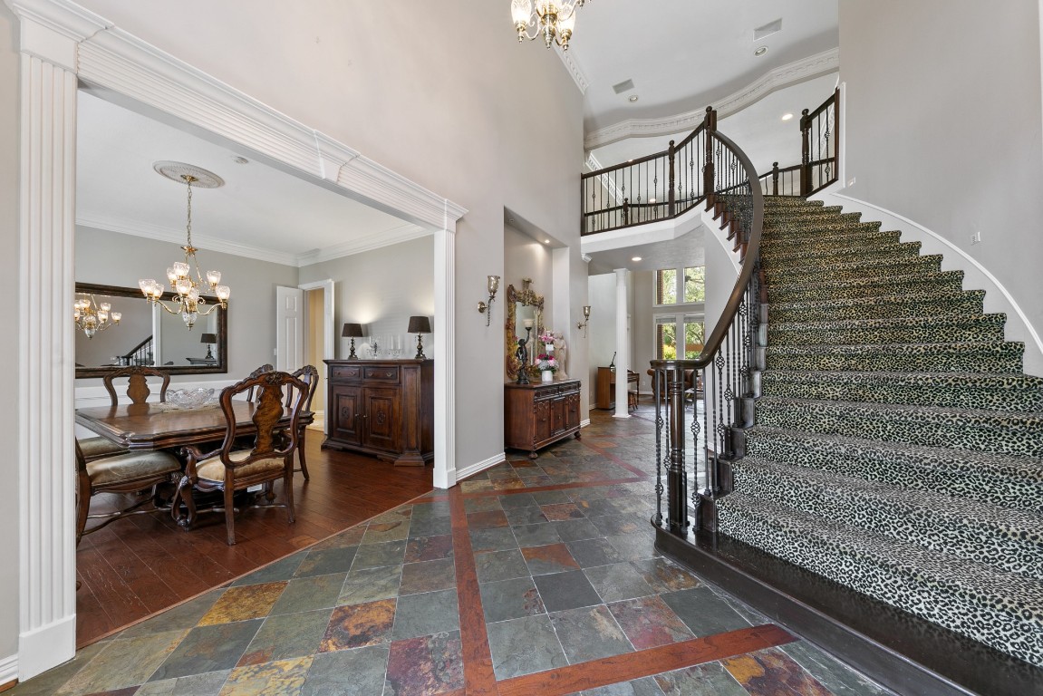 13915 Springmint Drive Cypress, TX 77429 - Photo 3 of 43 “Grand entry showcases soaring ceilings, elegant wrought iron staircases, and rich slate tile flooring—setting a sophisticated tone for this luxurious estate.”