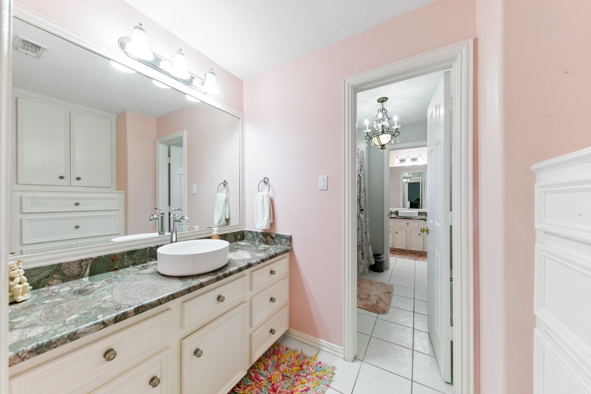 13915 Springmint Drive Cypress, TX 77429 - Photo 30 of 43 a spacious bathroom with a granite countertop sink and a mirror