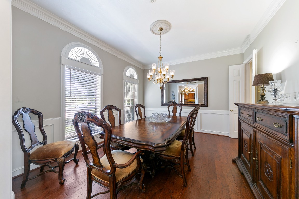 13915 Springmint Drive Cypress, TX 77429 - Photo 4 of 43 a dining room with furniture a chandelier and wooden floor