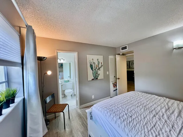 a bedroom with a bed and a mirror